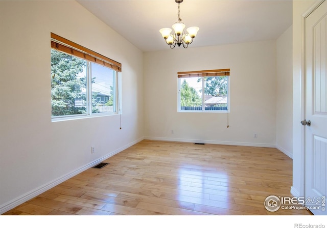 403 W Cannon St, Lafayette, CO 80026 - empty room with plenty of natural light, a chandelier, and light wood-style floors
