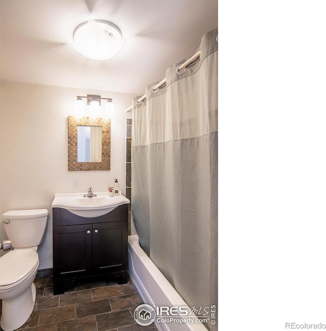 403 W Cannon St, Lafayette, CO 80026 - bathroom featuring shower / bathtub combination with curtain, vanity, and stone finish floors