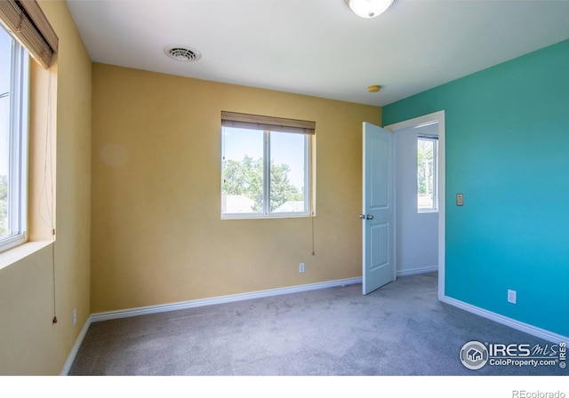 403 W Cannon St, Lafayette, CO 80026 - unfurnished bedroom featuring multiple windows and carpet floors