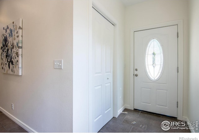 403 W Cannon St, Lafayette, CO 80026 - entryway featuring baseboards and dark tile patterned flooring
