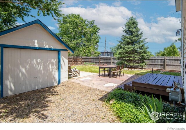 403 W Cannon St, Lafayette, CO 80026 - fenced backyard with a wooden deck, an outbuilding, and outdoor dining area