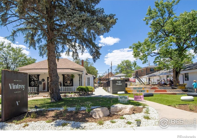 403 W Cannon St, Lafayette, CO 80026 - view of front of home featuring a front lawn, a porch, and a chimney