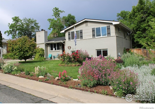 6864 Balsam St, Arvada, CO 80004 - split level home with a chimney and brick siding