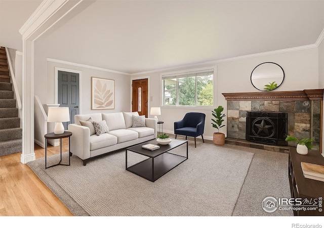 6864 Balsam St, Arvada, CO 80004 - living room with stairway, a fireplace, ornamental molding, and wood finished floors