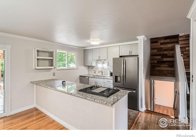 6864 Balsam St, Arvada, CO 80004 - kitchen featuring stainless steel appliances, a peninsula, light wood-type flooring, gray cabinets, and light stone counters
