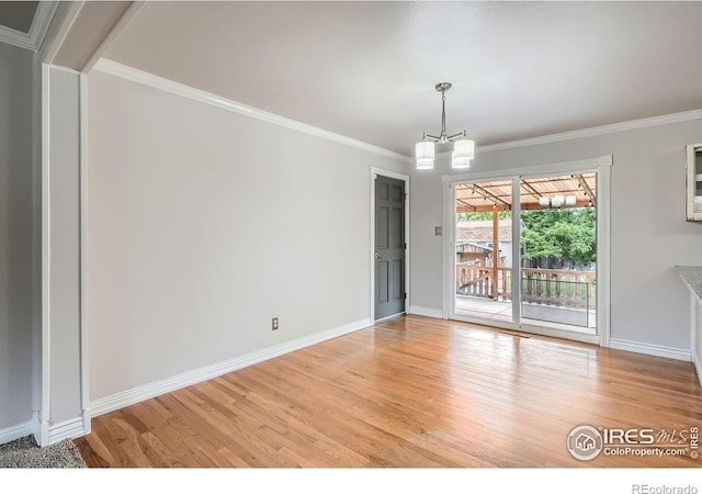 6864 Balsam St, Arvada, CO 80004 - empty room with light wood-style floors, ornamental molding, and a chandelier