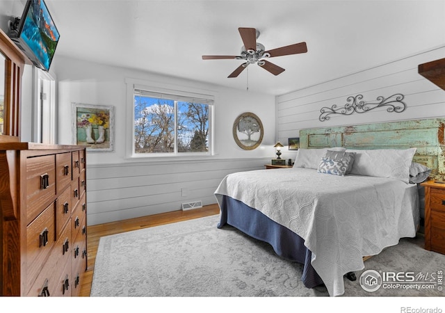 6864 Balsam St, Arvada, CO 80004 - bedroom with wooden walls, wood finished floors, and ceiling fan