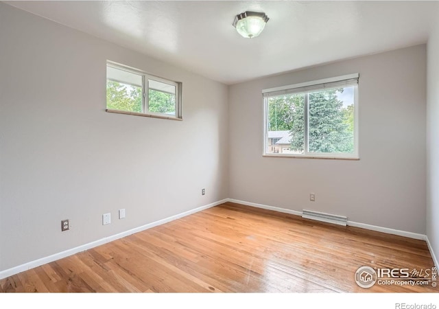 6864 Balsam St, Arvada, CO 80004 - unfurnished room featuring healthy amount of natural light and light wood finished floors