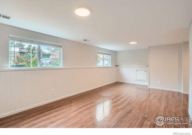 6864 Balsam St, Arvada, CO 80004 - empty room featuring wainscoting and light wood-style floors