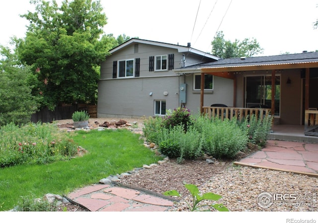 6864 Balsam St, Arvada, CO 80004 - back of house featuring a lawn