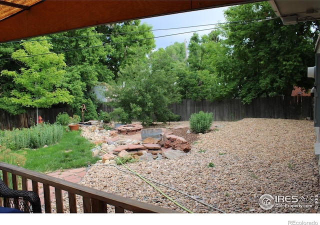 6864 Balsam St, Arvada, CO 80004 - fenced backyard with a fire pit