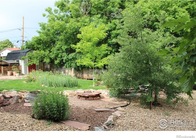 6864 Balsam St, Arvada, CO 80004 - view of yard featuring an outdoor fire pit and a storage shed