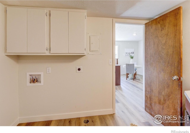 1343 E 7th St Unit 1, Loveland, CO 80537 - laundry room with cabinet space, hookup for an electric dryer, hookup for a washing machine, and light wood-style flooring