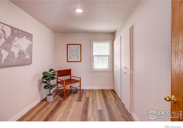 1343 E 7th St Unit 1, Loveland, CO 80537 - sitting room featuring light wood finished floors and a textured ceiling