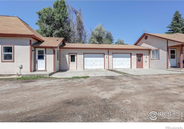 1343 E 7th St Unit 1, Loveland, CO 80537 - ranch-style home featuring a garage and dirt driveway