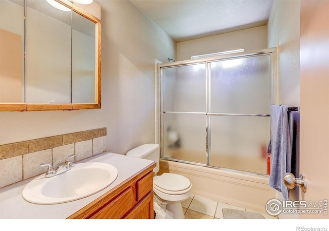 1343 E 7th St Unit 1, Loveland, CO 80537 - full bathroom featuring vanity, enclosed tub / shower combo, backsplash, and tile patterned flooring