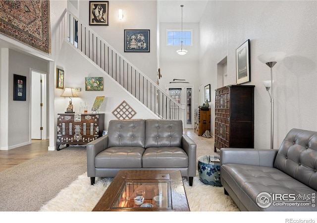 5072 Saint Andrews Dr, Loveland, CO 80537 - living room with a towering ceiling, carpet floors, and stairway