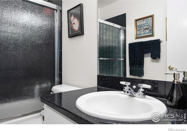 5072 Saint Andrews Dr, Loveland, CO 80537 - full bathroom featuring vanity and an enclosed shower