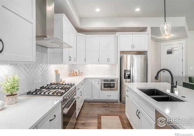 1550 Harebell St, Berthoud, CO 80513 - kitchen with wall chimney exhaust hood, appliances with stainless steel finishes, dark wood-type flooring, white cabinets, and recessed lighting