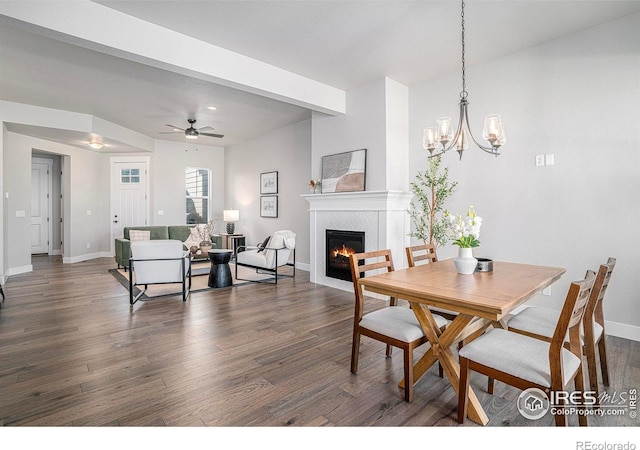 1550 Harebell St, Berthoud, CO 80513 - dining area featuring a glass covered fireplace, dark wood finished floors, a chandelier, and a ceiling fan