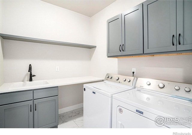 1550 Harebell St, Berthoud, CO 80513 - laundry area featuring cabinet space, light marble finish floors, and washing machine and dryer
