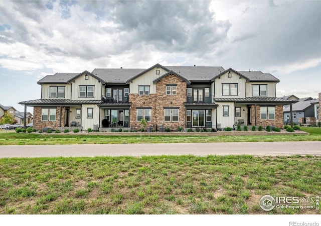 1550 Harebell St, Berthoud, CO 80513 - townhome / multi-family property featuring board and batten siding, a standing seam roof, and a metal roof