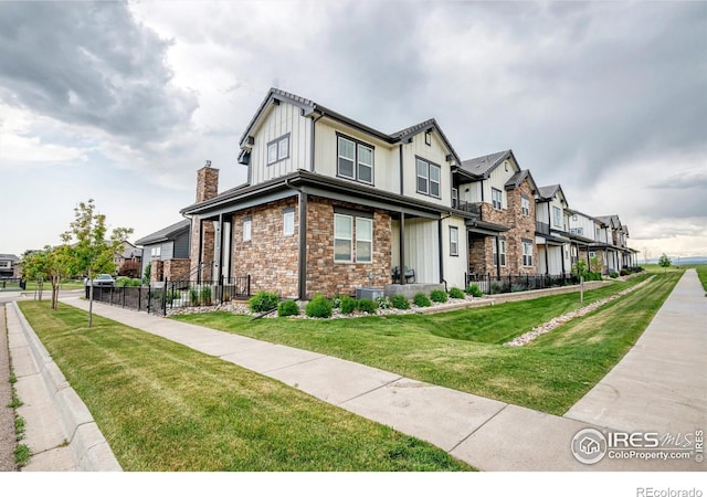 1550 Harebell St, Berthoud, CO 80513 - view of front of property featuring a residential view, stone siding, and a chimney