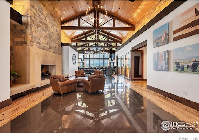 1550 Harebell St, Berthoud, CO 80513 - living room featuring a chandelier, high vaulted ceiling, a large fireplace, wood ceiling, and marble tiled flooring