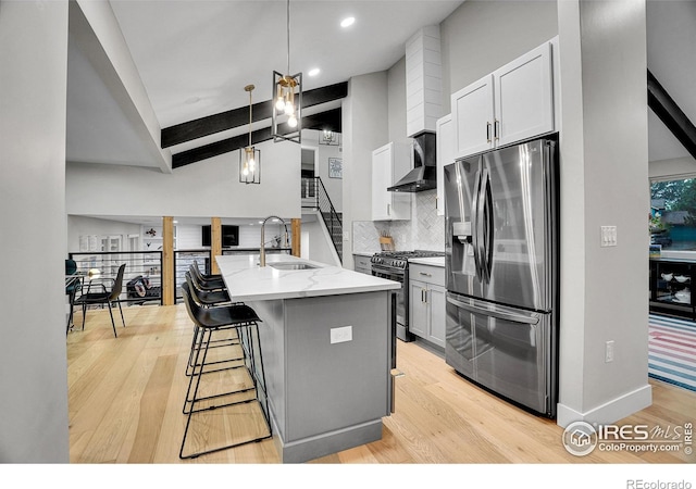 7146 Petursdale Ct, Boulder, CO 80301 - kitchen with stainless steel appliances, wall chimney range hood, light stone countertops, tasteful backsplash, and light wood-type flooring