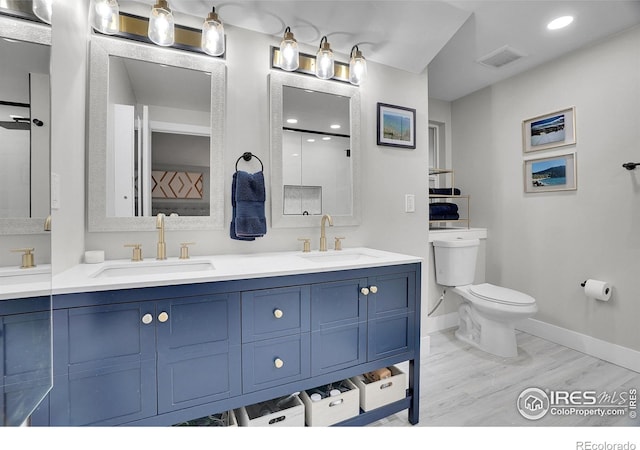 7146 Petursdale Ct, Boulder, CO 80301 - full bathroom with double vanity, wood finished floors, a shower, and recessed lighting