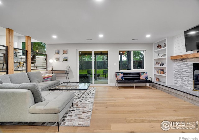 7146 Petursdale Ct, Boulder, CO 80301 - living area with wood finished floors, recessed lighting, built in shelves, stairway, and a fireplace