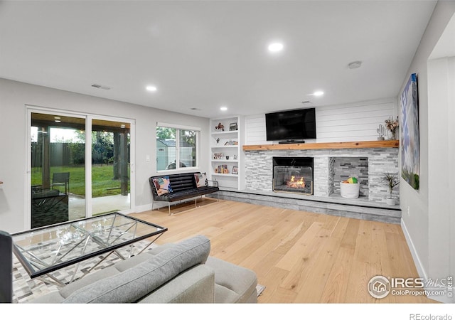 7146 Petursdale Ct, Boulder, CO 80301 - living room with wood finished floors, a fireplace, recessed lighting, and built in features
