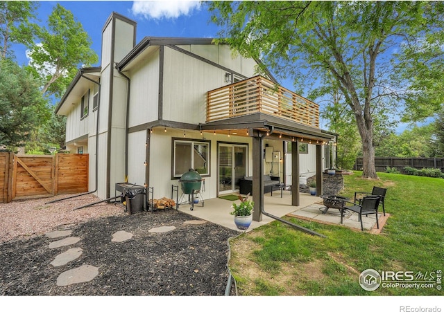 7146 Petursdale Ct, Boulder, CO 80301 - rear view of house with a fenced backyard, a gate, a chimney, a balcony, and a patio area