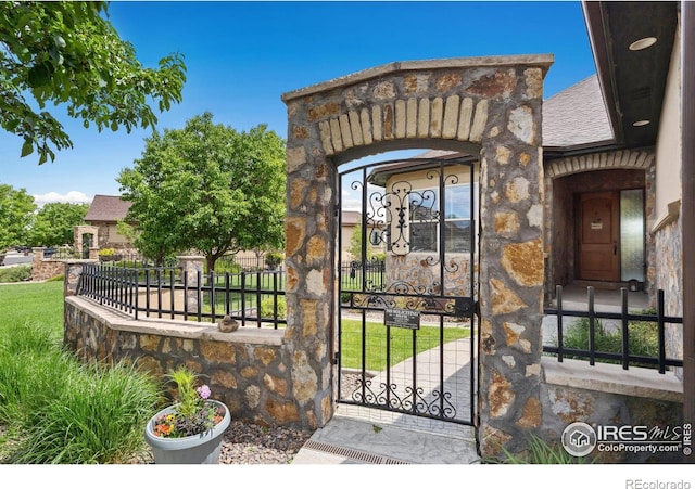 2055 Vineyard Dr, Windsor, CO 80550 - entrance to property featuring a gate and stone siding