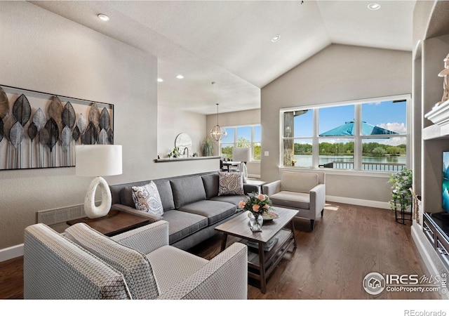 2055 Vineyard Dr, Windsor, CO 80550 - living area featuring lofted ceiling, wood finished floors, recessed lighting, and a water view