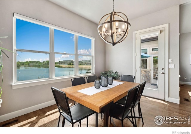 2055 Vineyard Dr, Windsor, CO 80550 - dining room with a chandelier, a water view, and wood finished floors