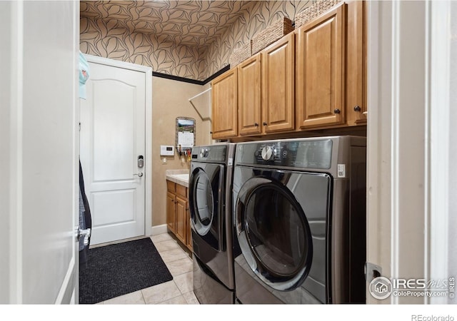 2055 Vineyard Dr, Windsor, CO 80550 - washroom with washer and dryer, cabinet space, wallpapered walls, and light tile patterned floors