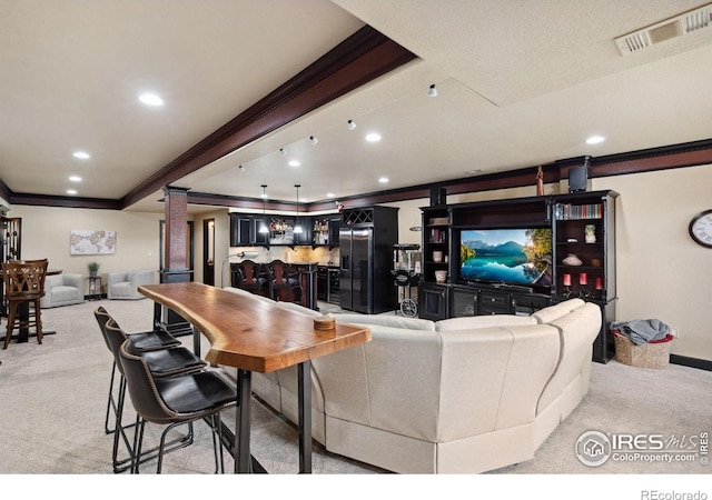 2055 Vineyard Dr, Windsor, CO 80550 - living area featuring crown molding, light colored carpet, bar area, ornate columns, and recessed lighting