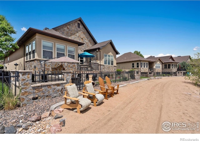 2055 Vineyard Dr, Windsor, CO 80550 - view of front of property with stone siding and stucco siding
