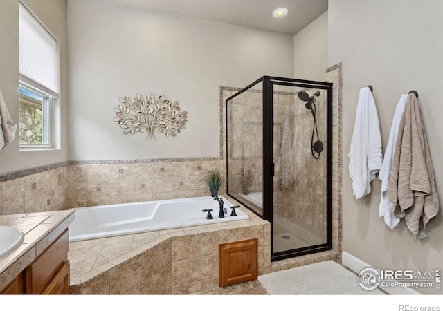 2055 Vineyard Dr, Windsor, CO 80550 - full bathroom featuring a bath, a stall shower, and vanity