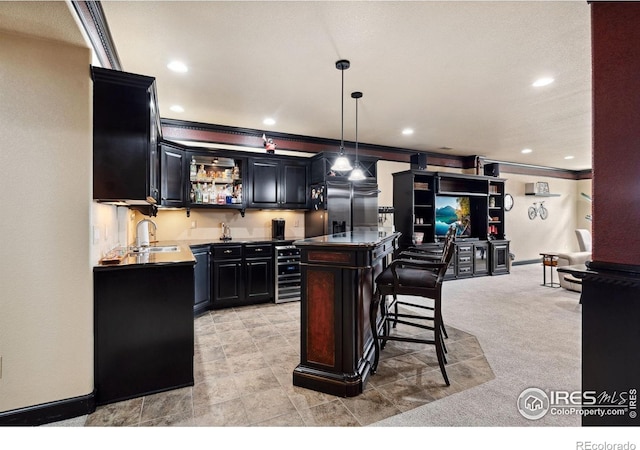 2055 Vineyard Dr, Windsor, CO 80550 - indoor wet bar featuring ornamental molding, stainless steel built in refrigerator, recessed lighting, pendant lighting, and light carpet