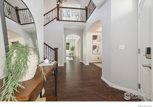 2133 Katahdin Dr, Fort Collins, CO 80525 - foyer entrance featuring stairway, arched walkways, wood finished floors, and a high ceiling