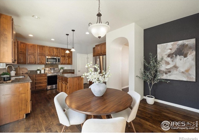 2133 Katahdin Dr, Fort Collins, CO 80525 - dining space with arched walkways, dark wood-type flooring, and recessed lighting