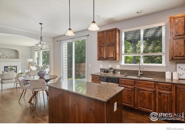 2133 Katahdin Dr, Fort Collins, CO 80525 - kitchen featuring a center island, dark wood-style floors, dark stone countertops, and healthy amount of natural light