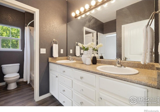 2133 Katahdin Dr, Fort Collins, CO 80525 - full bath with double vanity, wood finished floors, and shower / bath combo with shower curtain