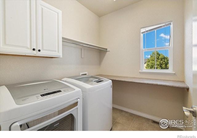 2133 Katahdin Dr, Fort Collins, CO 80525 - washroom featuring washer and dryer, cabinet space, and light tile patterned floors