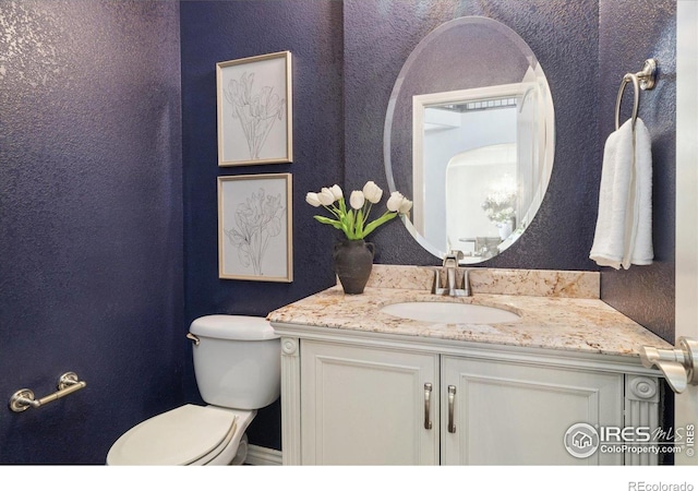 2133 Katahdin Dr, Fort Collins, CO 80525 - half bath featuring vanity and a textured wall