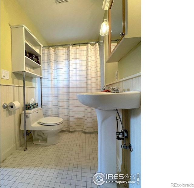 2204 Pine St, Boulder, CO 80302 - full bathroom featuring tile patterned flooring, wainscoting, and a shower with curtain