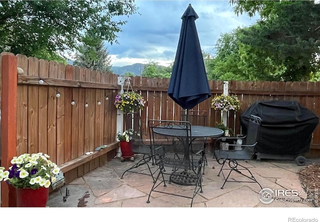 2204 Pine St, Boulder, CO 80302 - view of patio with a grill, outdoor dining space, and a mountain view