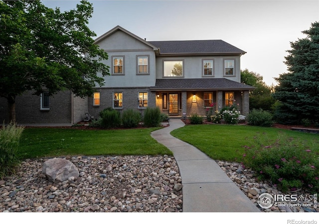 14601 Akron St, Brighton, CO 80602 - view of front facade featuring a front yard and stucco siding
